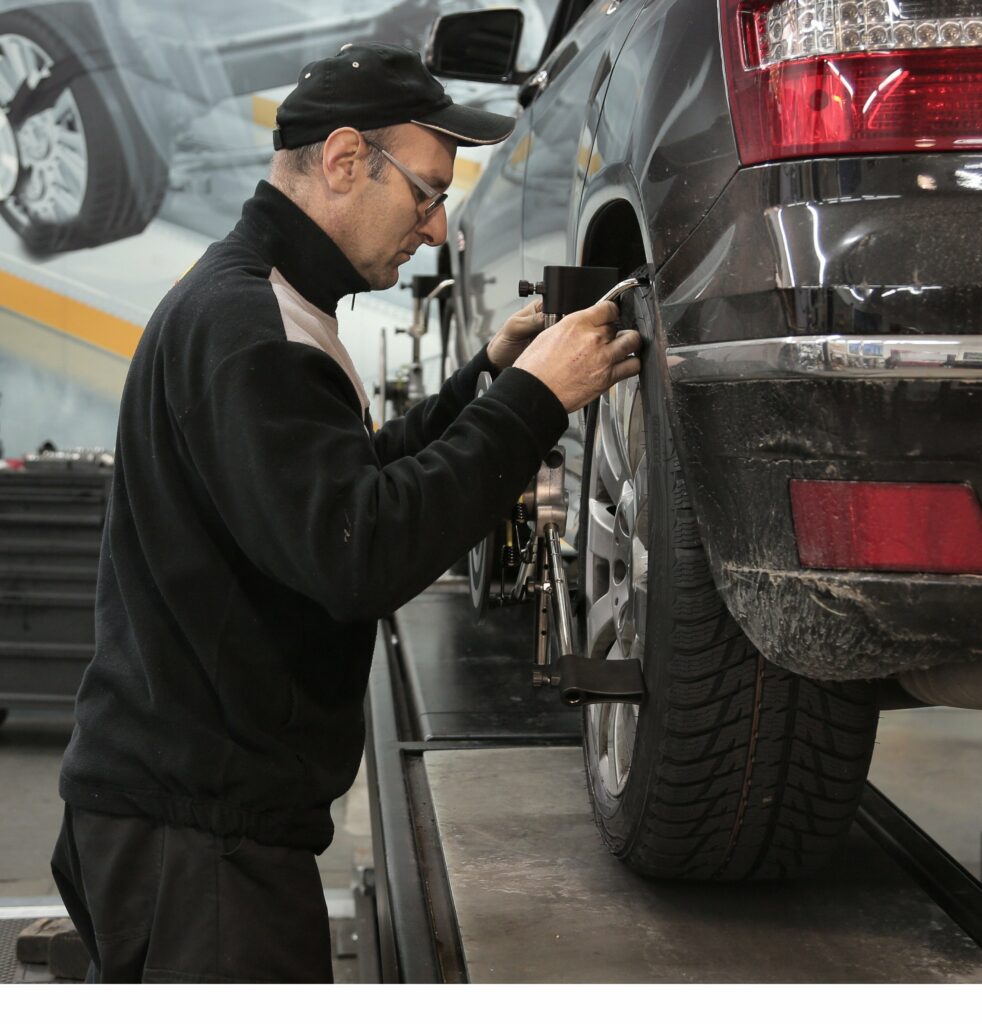 Man checking car tire pressure while car is using Insurance for HyreCar Fleet Owners